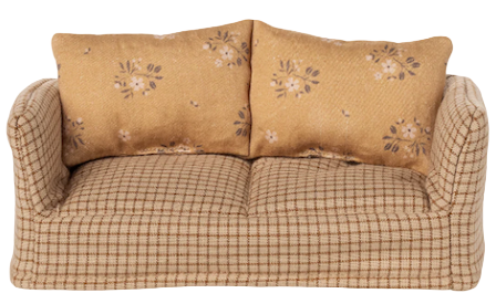 Beige checkered sofa with floral-patterned pillows on a beige background